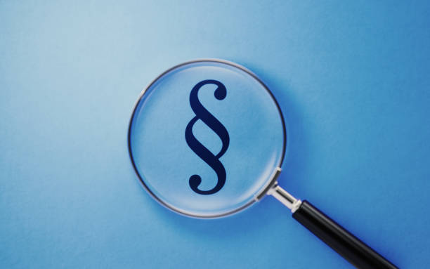 istock Law Concept - Magnifier And Law Symbol On Blue Background 1141746580