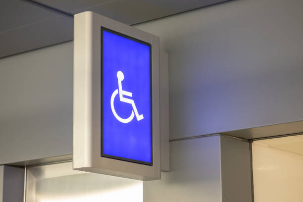 istock Close up of disabled handicap access sign light board for restroom on wall. 1141748250