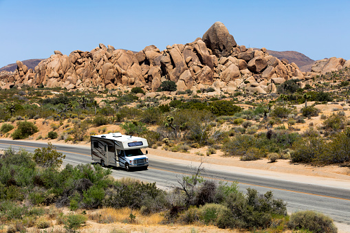 Motor home speeding on road in Joshua Tree National Park in southeastern California, United States.