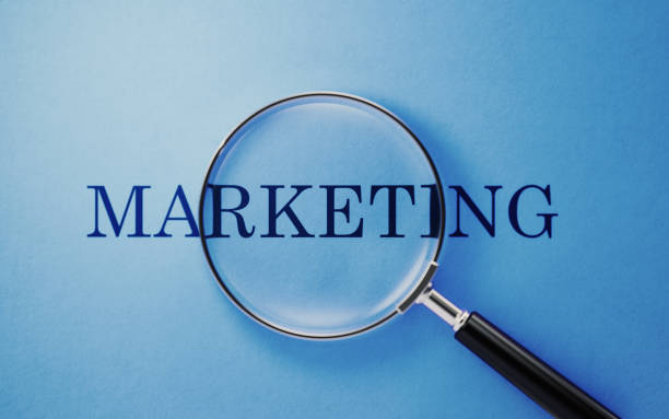 istock Marketing Concept - Magnifier And Marketing Text On Blue Background 1141748400