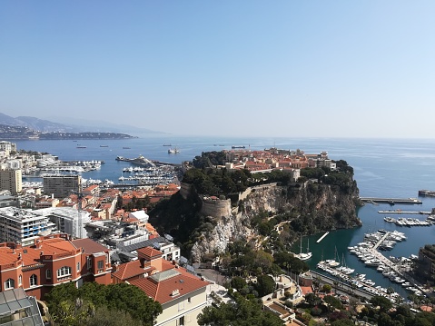 Rows of yachts in marina of Menton, old town is seen in the background, aerial view, Cote d'Azur, French Riviera, France, Europe.