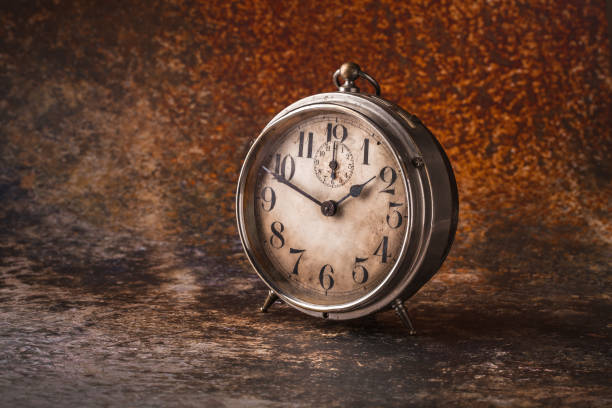 istock Old rustic clock front view arrangement on vibrant color background 1141752998