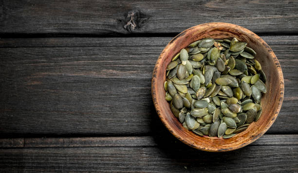istock Pumpkin seeds in bowl. 1141753388