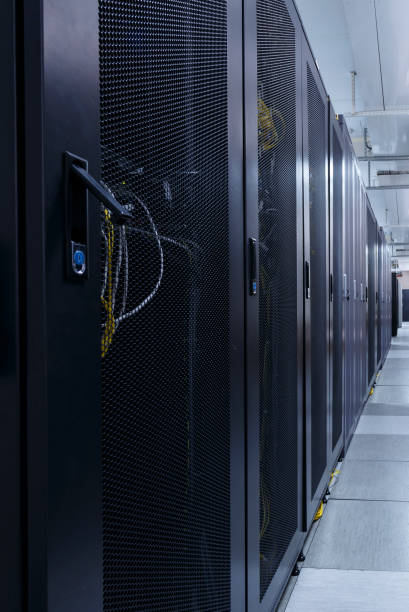 istock Long corridor in server room with rows of hardware in big data center. 1141753582