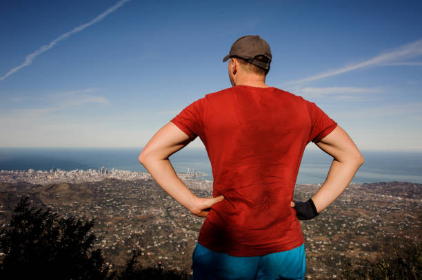 istock Strong man standing and looking on the mountains 1141753750