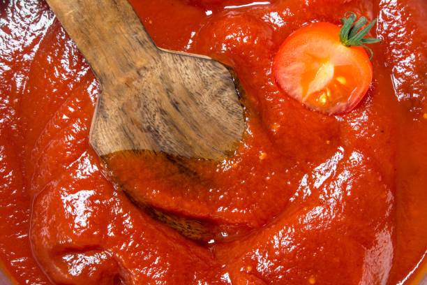 istock Tomato sauce with a wooden scoop. 1141753901