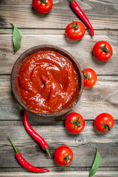 istock Tomato sauce in bowl with red hot pepper. 1141755232