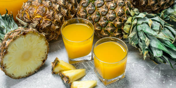 istock Fresh pineapple juice and ripe pineapples. 1141755272