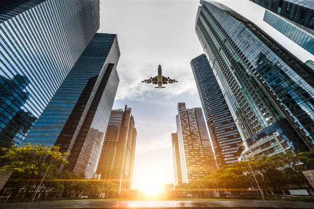 istock Airplane flying over Central Business District in Singapore 1141756330
