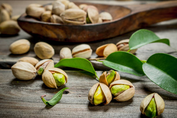 istock Pistachios with green leaves . 1141757043