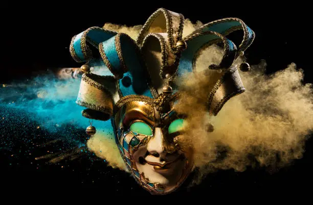 Coloured powder explosion with Venice mask. Freeze motion, art background