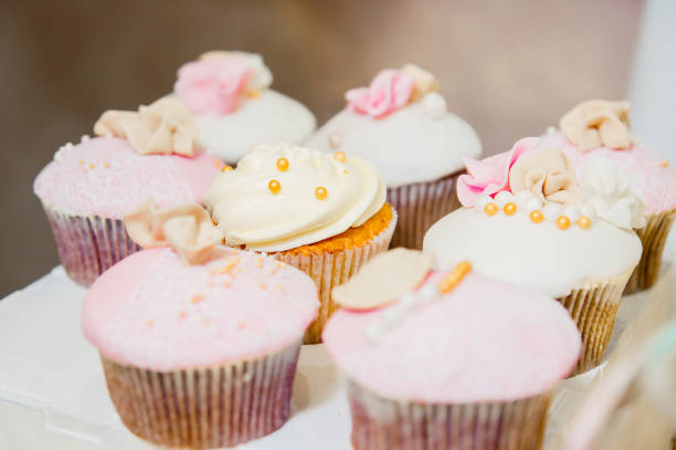 istock some cupcakes with white and pink cream and golden sparkles 1141759473