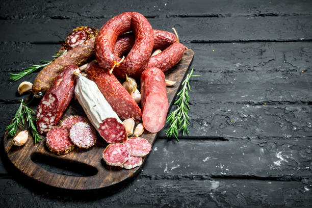 istock Different types of salami with spices and herbs. 1141759590
