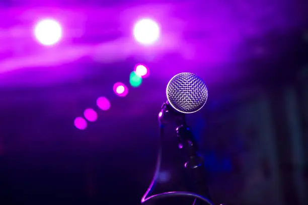 Photo of the microphone under the stage lights with bokeh