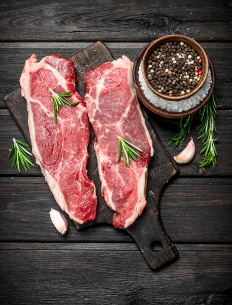 istock Raw beef steaks with salt and spices. 1141760064