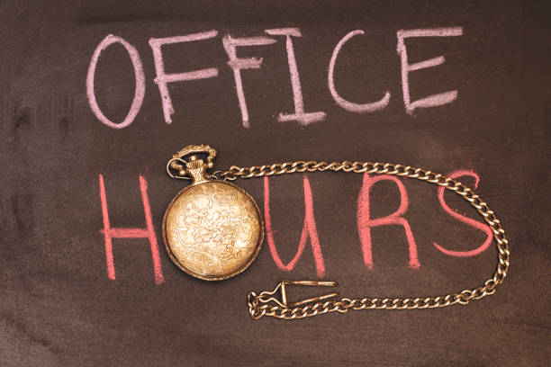 handwriting office hours with colorful chalk and antique watch