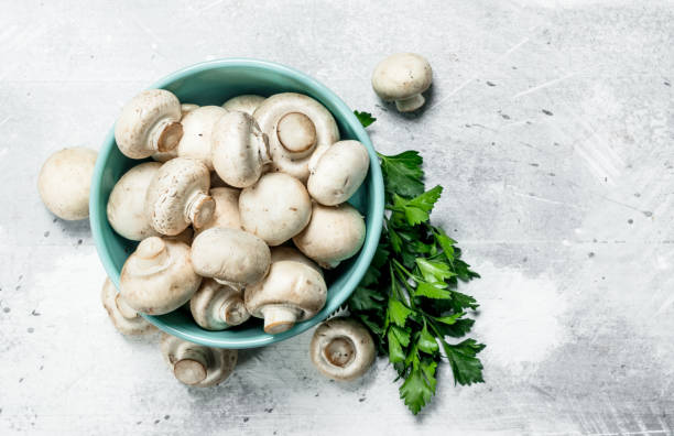 istock Ripe mushrooms in a bowl with foliage. 1141760147