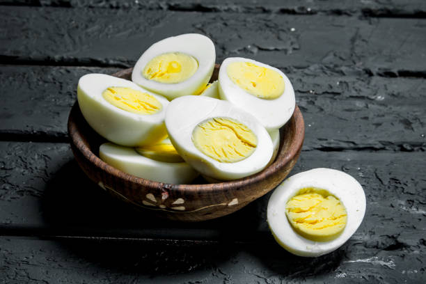Boiled eggs in bowl. Boiled eggs in bowl. On a black rustic background. boiled egg photos stock pictures, royalty-free photos & images