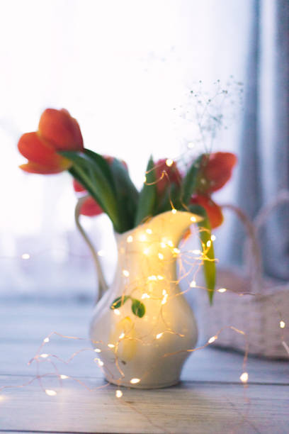Tulips in a vase on a wooden background.