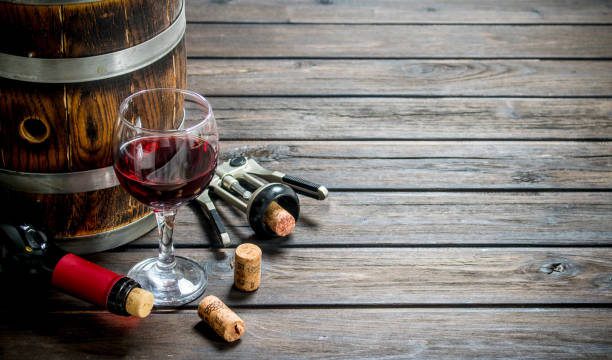 istock Wine background. A barrel of red wine with a corkscrew. 1141762184