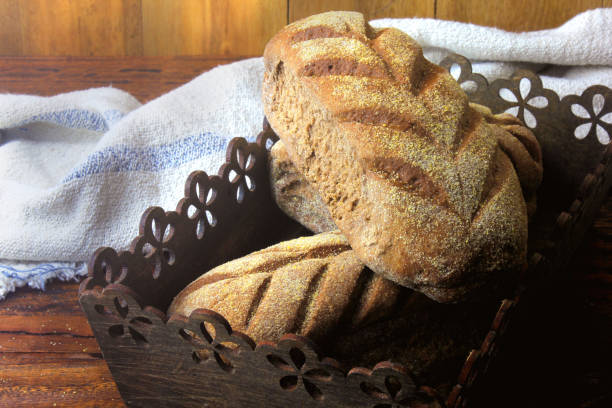 istock Australian bread loaf in basket over rustic wooden background. Traditionally this bread is made with chocolate powder, brown sugar and honey. Top view 1141762955