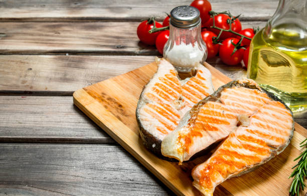 istock Grilled salmon with tomatoes and spices. 1141763035