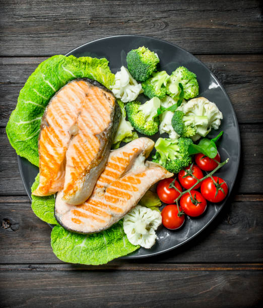 istock Grilled salmon steaks with tomatoes and broccoli on a plate. 1141763211