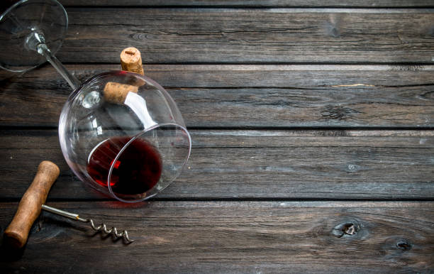 istock Red wine in a wine glass with a corkscrew. 1141763384