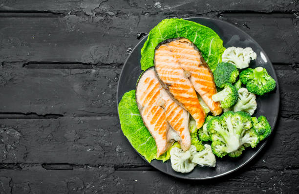 istock Grilled salmon steaks with fresh broccoli in a plate. 1141763563