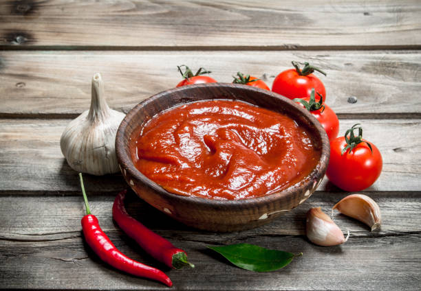 istock Tomato sauce in bowl with red hot pepper. 1141763661