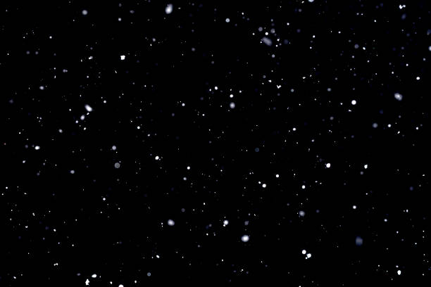 istock Falling snow on black background Snowflakes Flying in the air. 1141765215