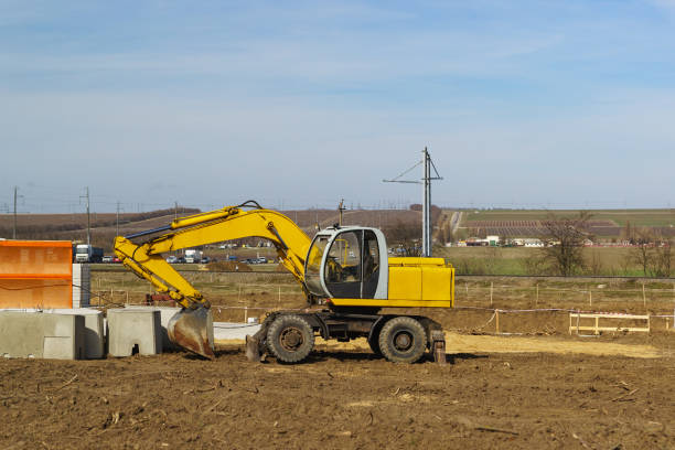 istock Empty yellow excavator stands during lunch break. Construction of a road junction at a railway crossing near the village Starotitarovskaya Temryuk district 1141765244