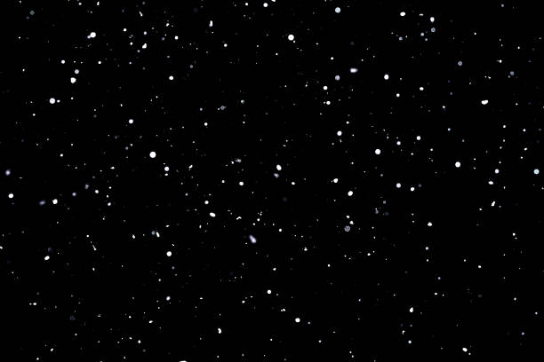 istock Falling snow on black background Snowflakes Flying in the air 1141765376