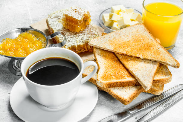 istock Breakfast. Toasted bread with butter, honey and orange jam. 1141765396