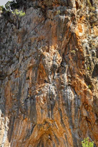 istock Young Rock Climber ascending steep colourful rocky Wall Lead Climbing 1141766085