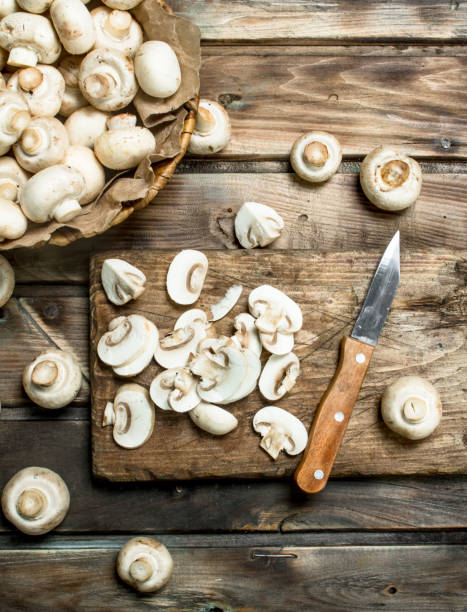 istock Cut mushrooms on a cutting Board with a knife. 1141766189