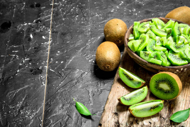 istock Kiwi slices in a bowl on a cutting Board. 1141766398