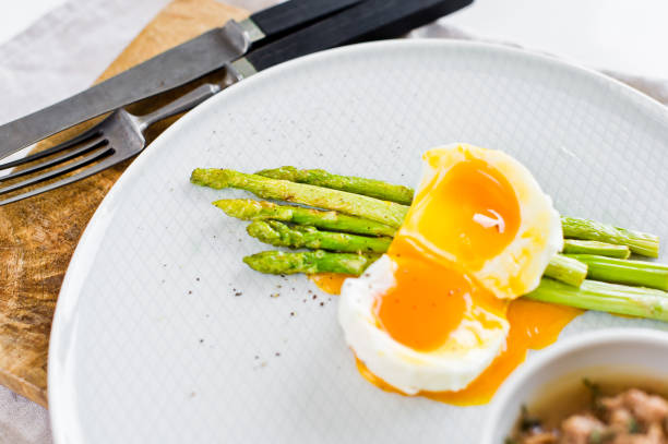 istock Baked mini asparagus with egg and tuna. White background, top view. 1141766558
