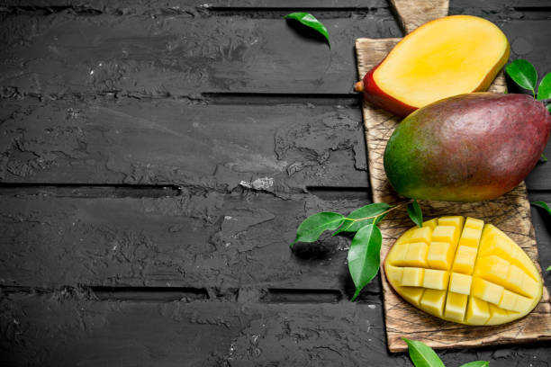 istock Whole and pieces of mango on the cutting Board. 1141766810