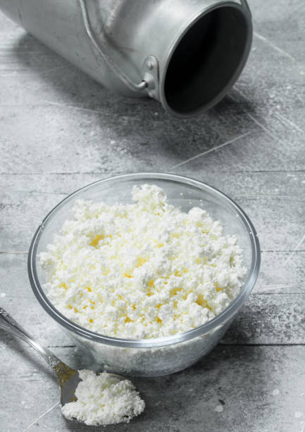 istock Cottage cheese in a bowl with a milk can. 1141768259