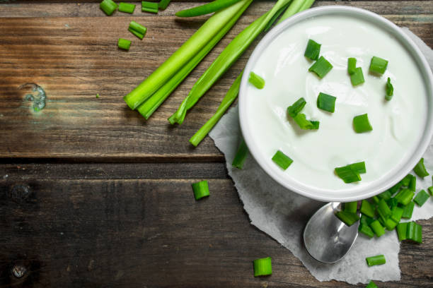 istock Fresh sour cream in bowl with green onions . 1141769103
