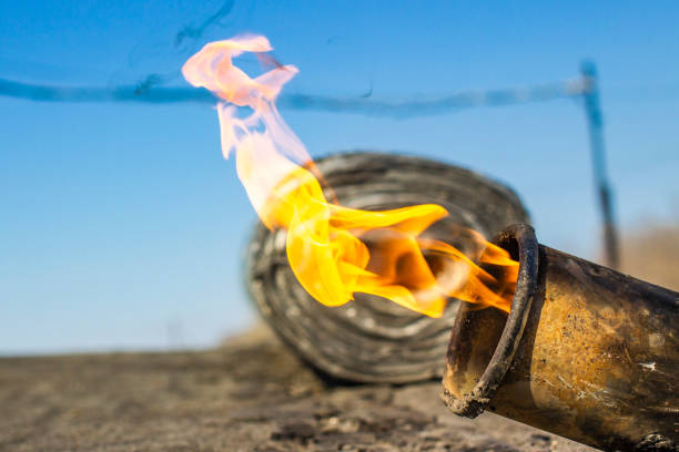 istock gas burner with fire and roll of roofing material on blurred background with bokeh effect 1141769119