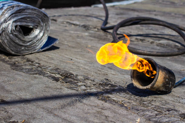 istock gas burner with fire and roll of roofing material on blurred background with bokeh effect 1141769125