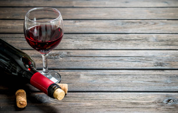 istock Wine background. Red wine in a bottle with a glass. 1141769524