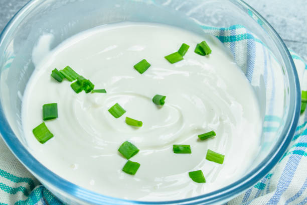 istock Sour cream in bowl with green onions. 1141769549