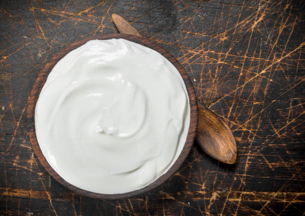 istock Fresh sour cream in bowl with spoon . 1141769583