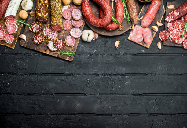 istock Different types of salami on wooden Board. 1141770772