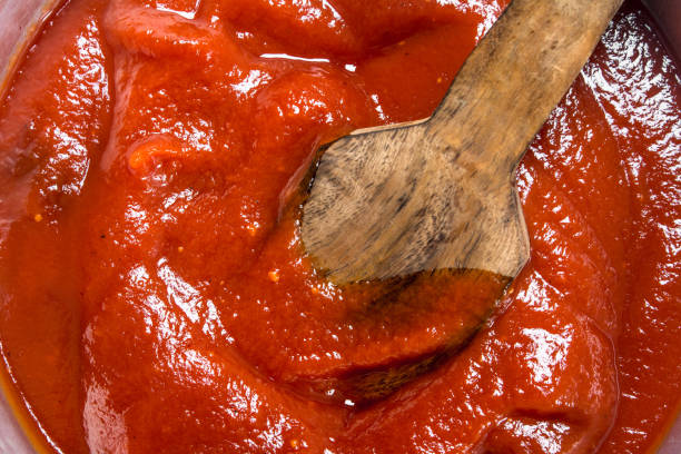 istock Tomato sauce with a wooden scoop. 1141770993