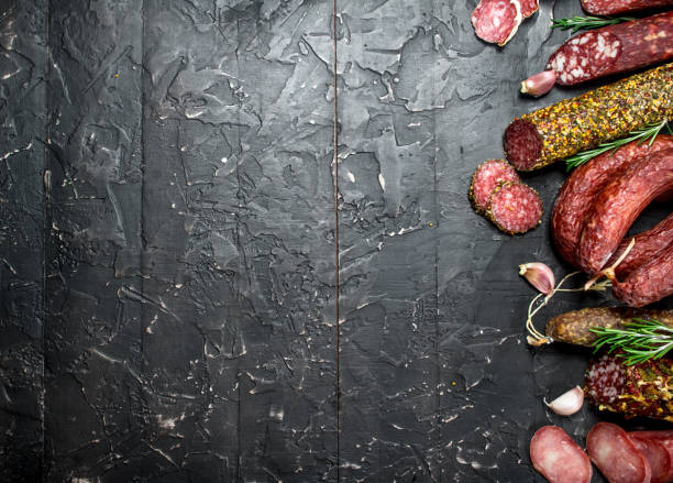 istock Assortment of different salami with spices and herbs. 1141771046