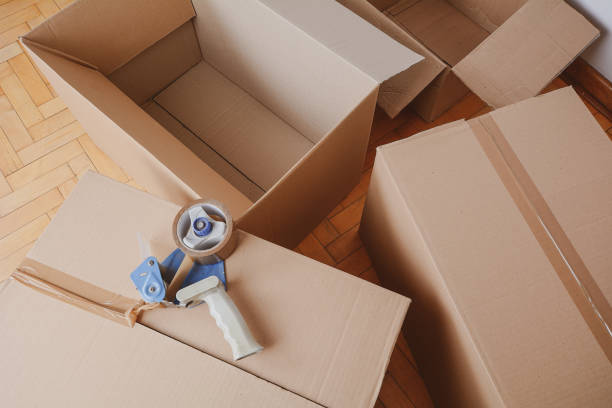 istock Tape dispenser sealing a shipping cardboard box 1141771735